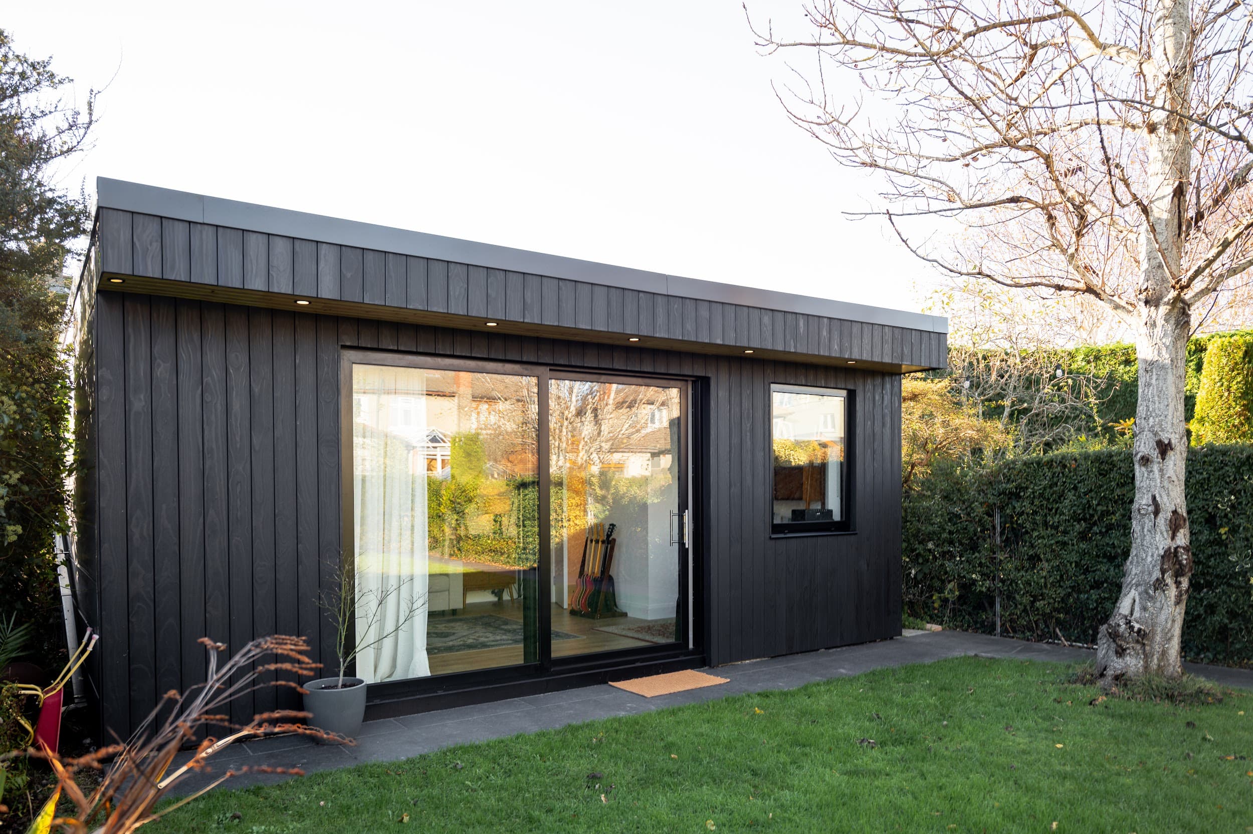 Exterior of a finished black timber garden room in a Dublin garden