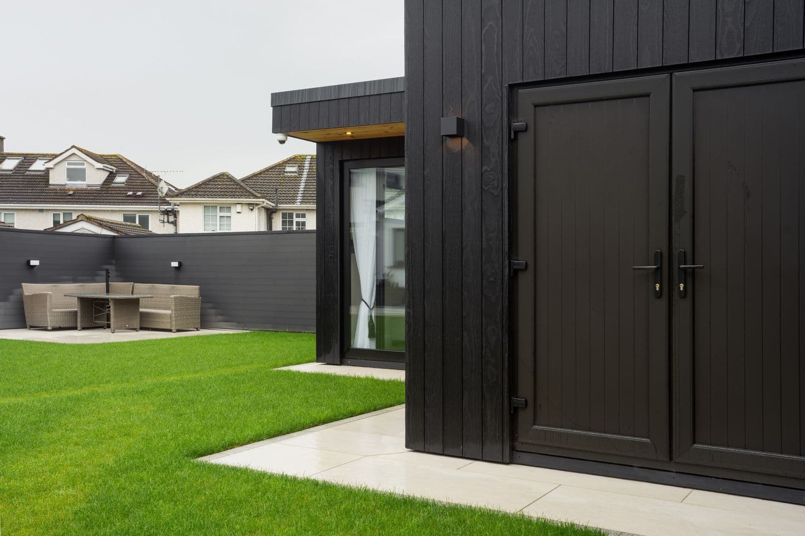 Garden office exterior with sliding doors onto the lawn