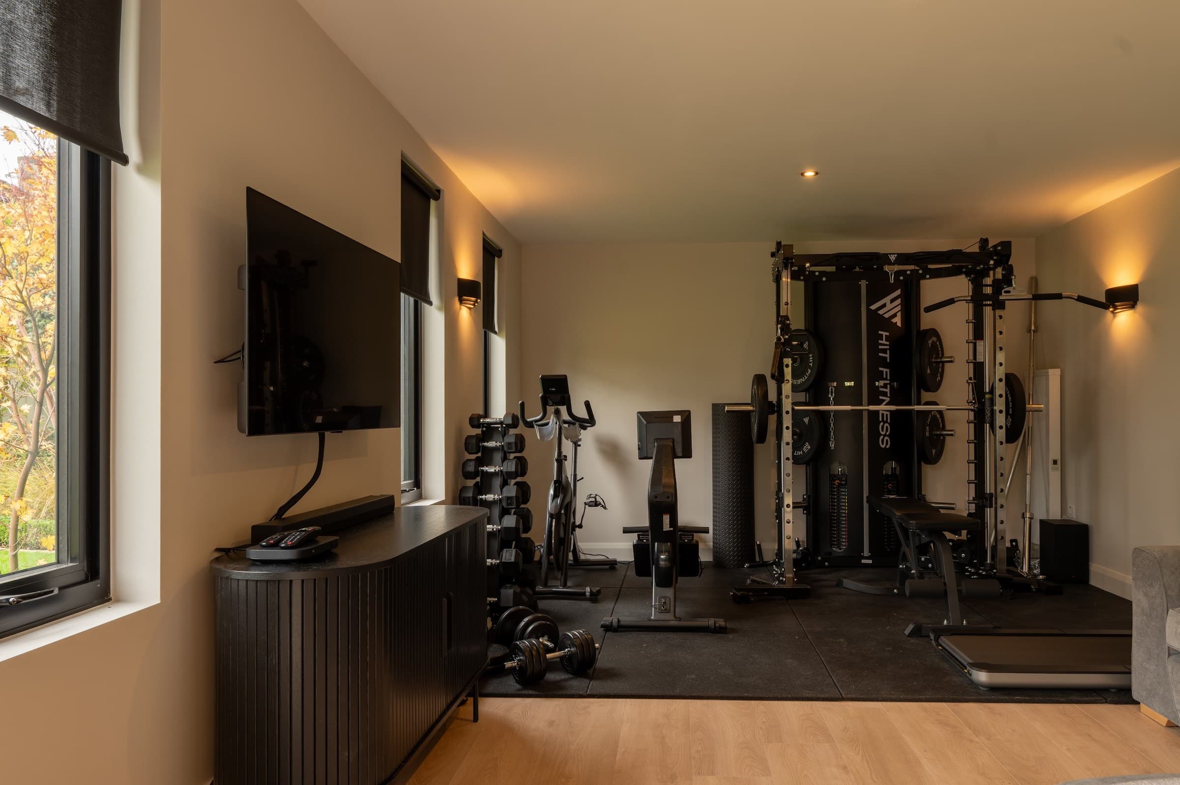Bright garden gym interior with weights, mirrors and natural light