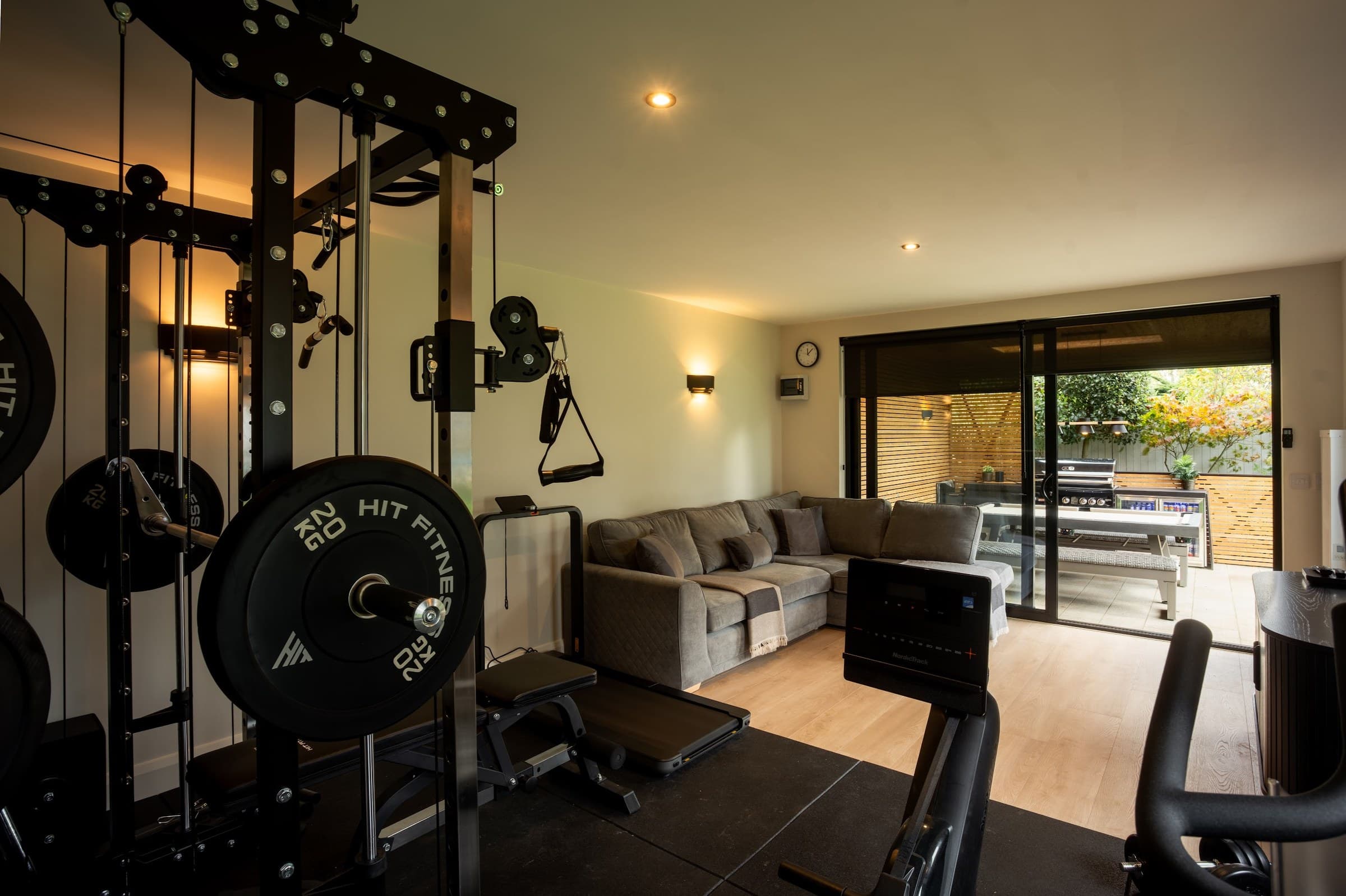Garden gym interior with rubber flooring, weight rack and natural light